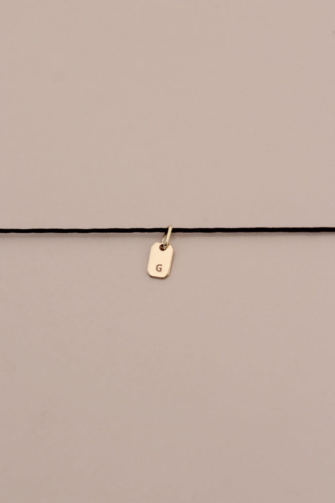 STRIKE A CORD TAG LETTER NECKLACE