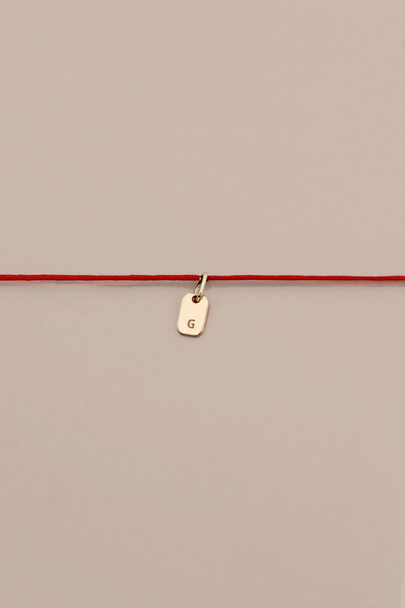 STRIKE A CORD TAG LETTER NECKLACE