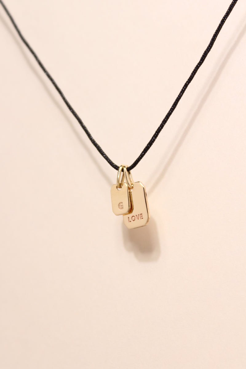 STRIKE A CORD TAG LETTER NECKLACE